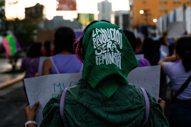 photo of a woman with a green scarf that says: ​