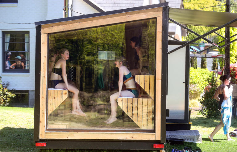 Deanne O’Dell, of Edmonds, left, and Lara Deits, of Bainbridge, right, relax in the sauna after their cold plunge while taking part in a HiLoFlo class at Fire+Floe in Bainbridge Island’s Lynwood Center on Thursday, May 9, 2024.