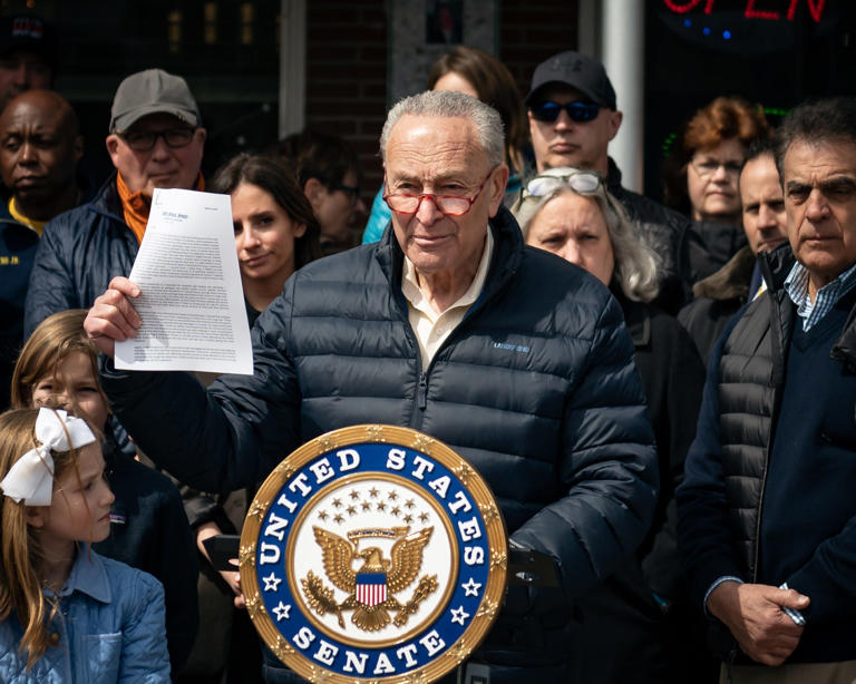 Majority Leader of the United States Senate Charles E. Schumer stands with his letter to Verizon at Ridgewood Market in South Utica on Friday, April 7, 2023. Schumer publicly called on Verizon to investigate and fix the "dead zone" where phone service drops.