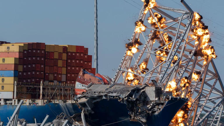 Explosive charges are detonated to bring down sections of the collapsed Francis Scott Key Bridge resting on the container ship Dali on Monday in Baltimore. - Mark Schiefelbein/AP