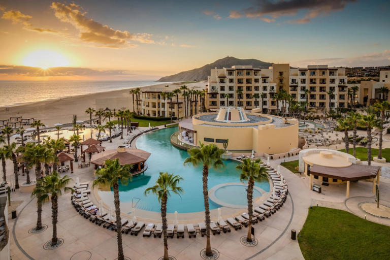 photo of the Pueblo Bonito resort, including the beach at sunset, a large pool, and multiple buildings
