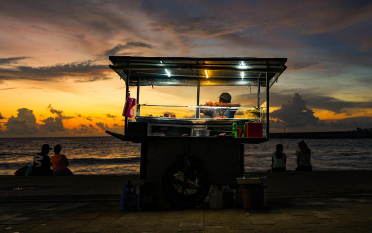 A street food vendor selling roti, crabs and prawns by the beach in Colombo - Getty