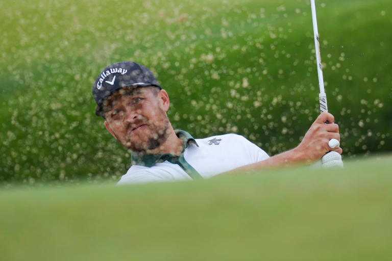 May 14, 2024; Louisville, Kentucky, USA; Xander Schauffele plays a shot from a bunker on the 18th green during a practice round for the PGA Championship golf tournament at Valhalla Golf Club. Mandatory Credit: Aaron Doster-USA TODAY Sports