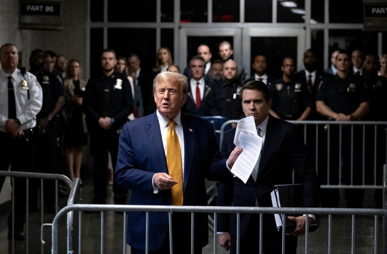 Former President Donald Trump, standing with defense attorney Todd Blanche, speaks to the media at the end of the day's proceedings in his trial for allegedly covering up hush money payments linked to an extramarital affair with Stormy Daniels, at Manhattan Criminal Court on May 14, 2024 in New York City.