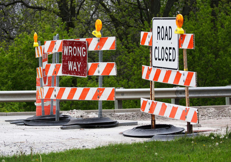 Signs tell motorists that access to a northbound section of North Rapids Road is closed, Monday, May 13, 2024, in Manitowoc, Wis.