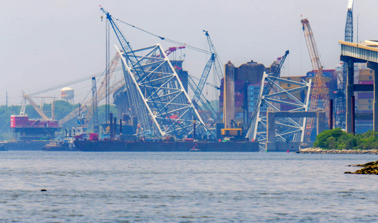 Crews continue removing debris and wreckage around the container ship Dali at the site of the March collapse of the Francis Scott Key Bridge in an effort to clear the shipping channel.