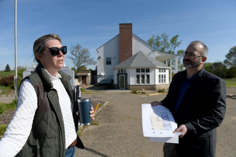 Sarah Buell, capital projects and planning manager, and Dan Moeglin, executive director of Stark Parks, talk about planned changes at Tam O'Shanter Park in Jackson Township while standing in front of the clubhouse.