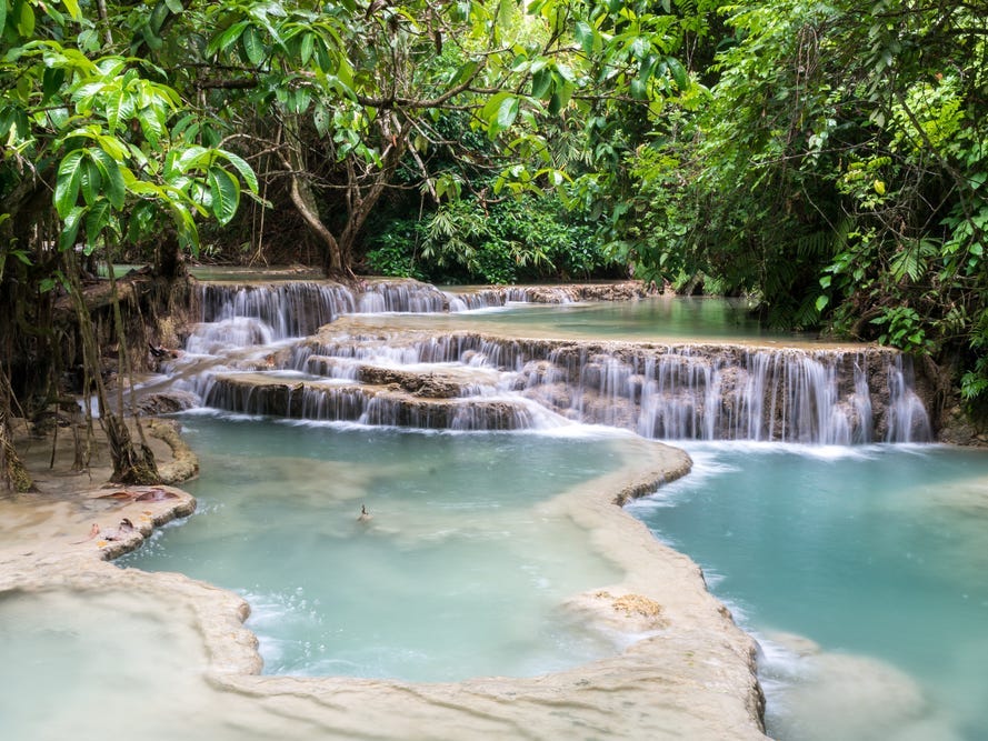 <p>When we traveled to Laos, we were blown away by the genuine, kind-hearted people and <a href="https://www.businessinsider.com/most-beautiful-places-to-visit-in-us-2024-1">spectacular natural scenery</a>.</p><p>Our favorite place we visited in this Southeast Asian country was Kuang Si Falls, where swimming is permitted in certain parts of the three-tiered, turquoise waterfalls. </p><p>Another thing we loved about Laos was the fresh and delicious food. After a day of exploring, we'd head to the local markets for some larb — a meat-based salad flavored with mint leaves, fish sauce, lime juice, and chiles.</p>