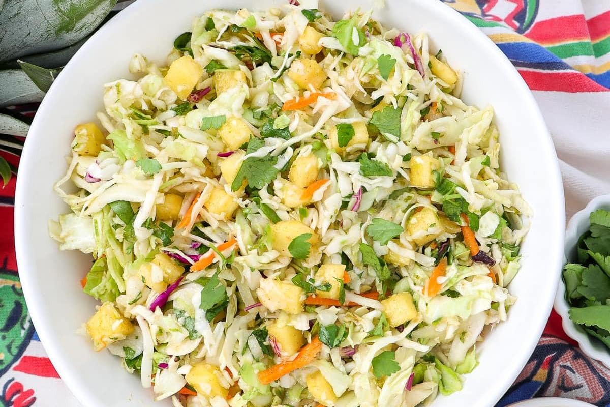 <p>This authentic Mexican cabbage slaw recipe is complete with a zesty lime dressing for a fresh-tasting, brightly colored side dish that pops on any dinner table or potluck spread.</p> <p>Get The Recipe: <strong><a href="https://intentionalhospitality.com/authentic-mexican-cabbage-slaw-recipe/">Mexican Pineapple Slaw With Zesty Dressing</a></strong></p>