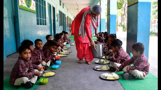 Kindergarten students of a primary government school having mid day meal in Ludhiana on Thursday.