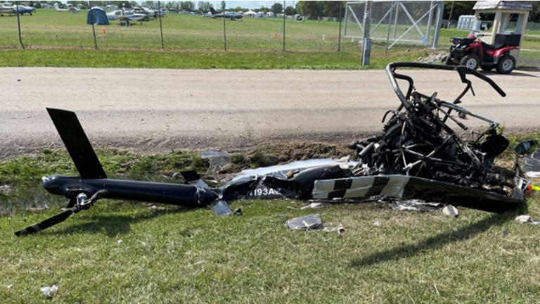 Burned wreckage of a helicopter that crashed after colliding with a gyrocopter during EAA AirVenture in Oshkosh