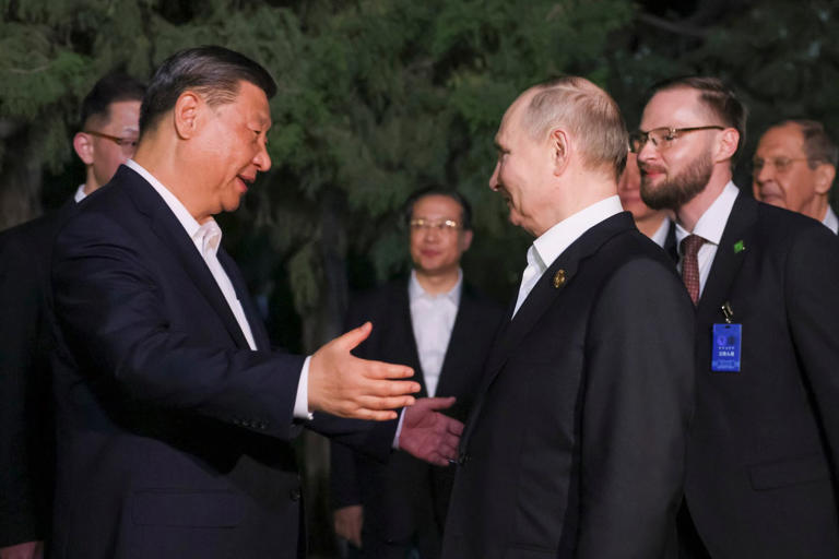 China president Xi Jinping extends arms for a hug to Russian president Vladimir Putin in Beijing