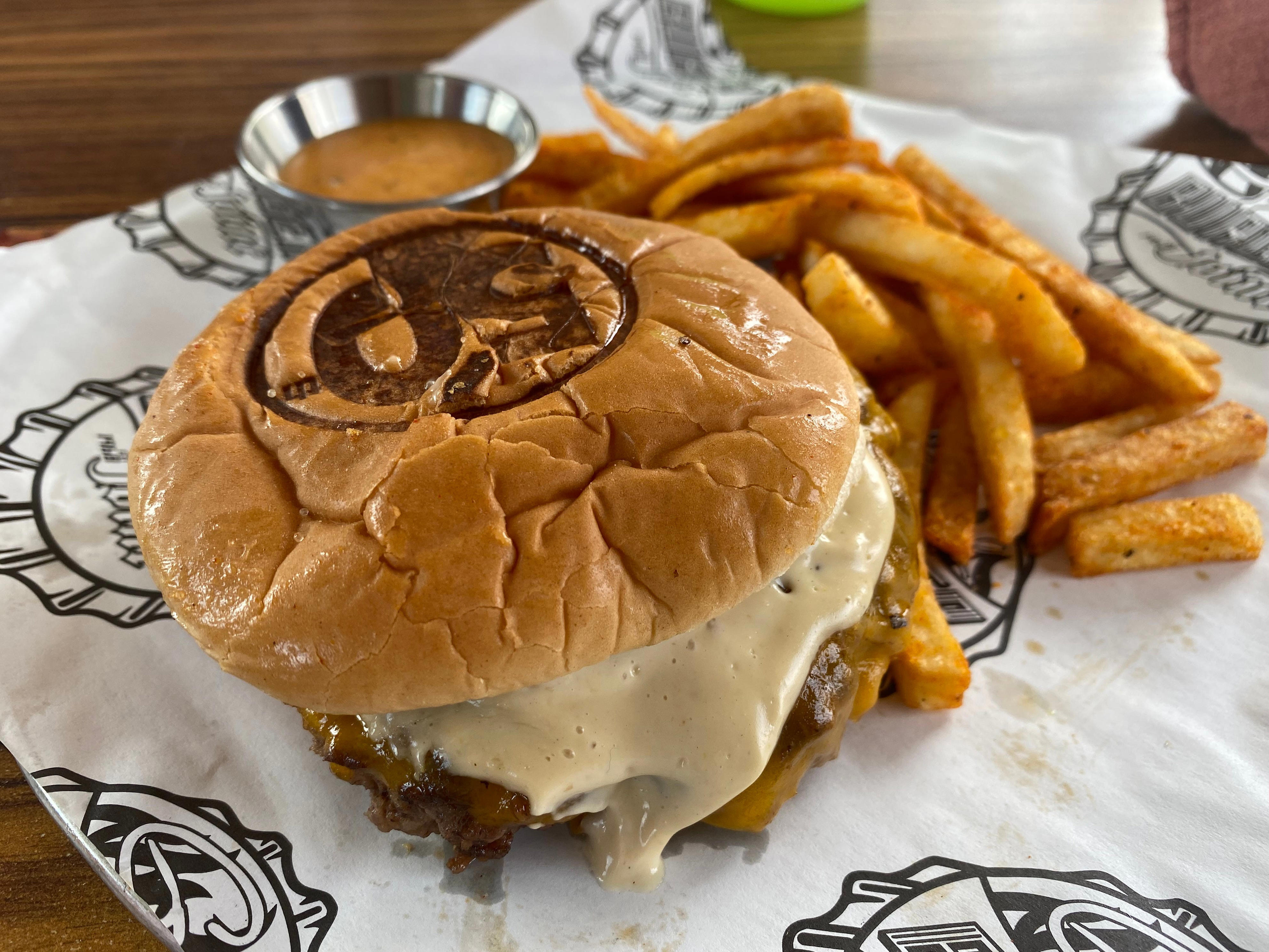 <p>I was excited to try the Straight Up burger, which had the same toasted bun and smashed burger patty as the Pig Patty. </p><p>The toppings were supposed to include cheese, lettuce, tomato, onion, pickle, and a generous slathering of Donkey Sauce (Fieri's signature garlic aioli). </p><p>When I got the Straight Up burger, it didn't have lettuce, tomatoes, or pickles, but it didn't really need them. The Donkey Sauce and cheese added plenty of flavor.</p>