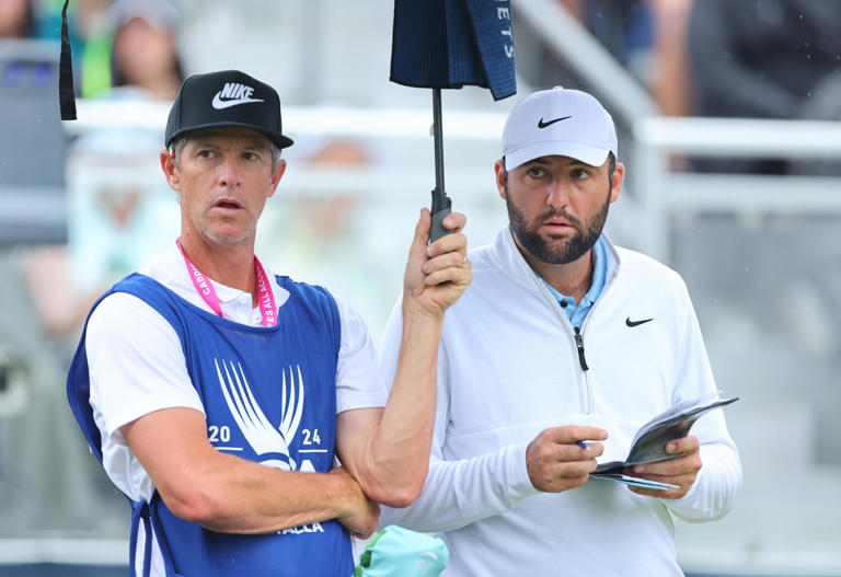 Scottie Scheffler and caddie, Ted Scott, look on from the tenth tee during the second round of the 2024 PGA Championship.