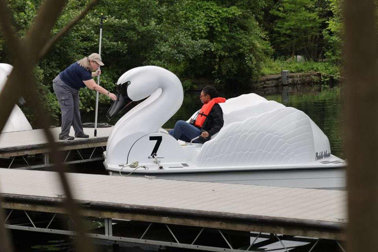 The new Swan Voyage paddleboat ride opened at the Cleveland Metroparks Zoo on Wednesday, May 15, 2024. Guests can paddle around Waterfowl Lake in the new Trumpeter Swan boats. Janell Craig, the social media coordinator at Destination Cleveland, sets sail on a solo voyage around Waterfowl Lake.  David Petkiewicz, cleveland.com