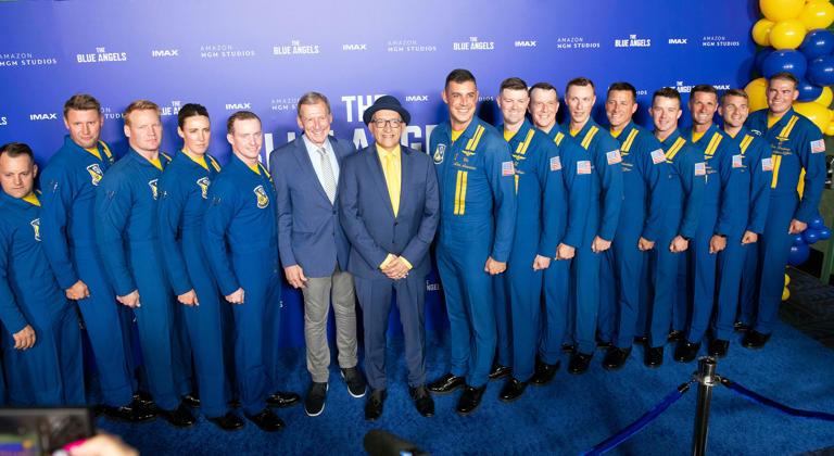 Director Paul Crowder and Blue Angels team members pose for photos on the red carpet for the premiere showing of the new IMAX film The Blue Angels on Thursday, May 16, 2024.