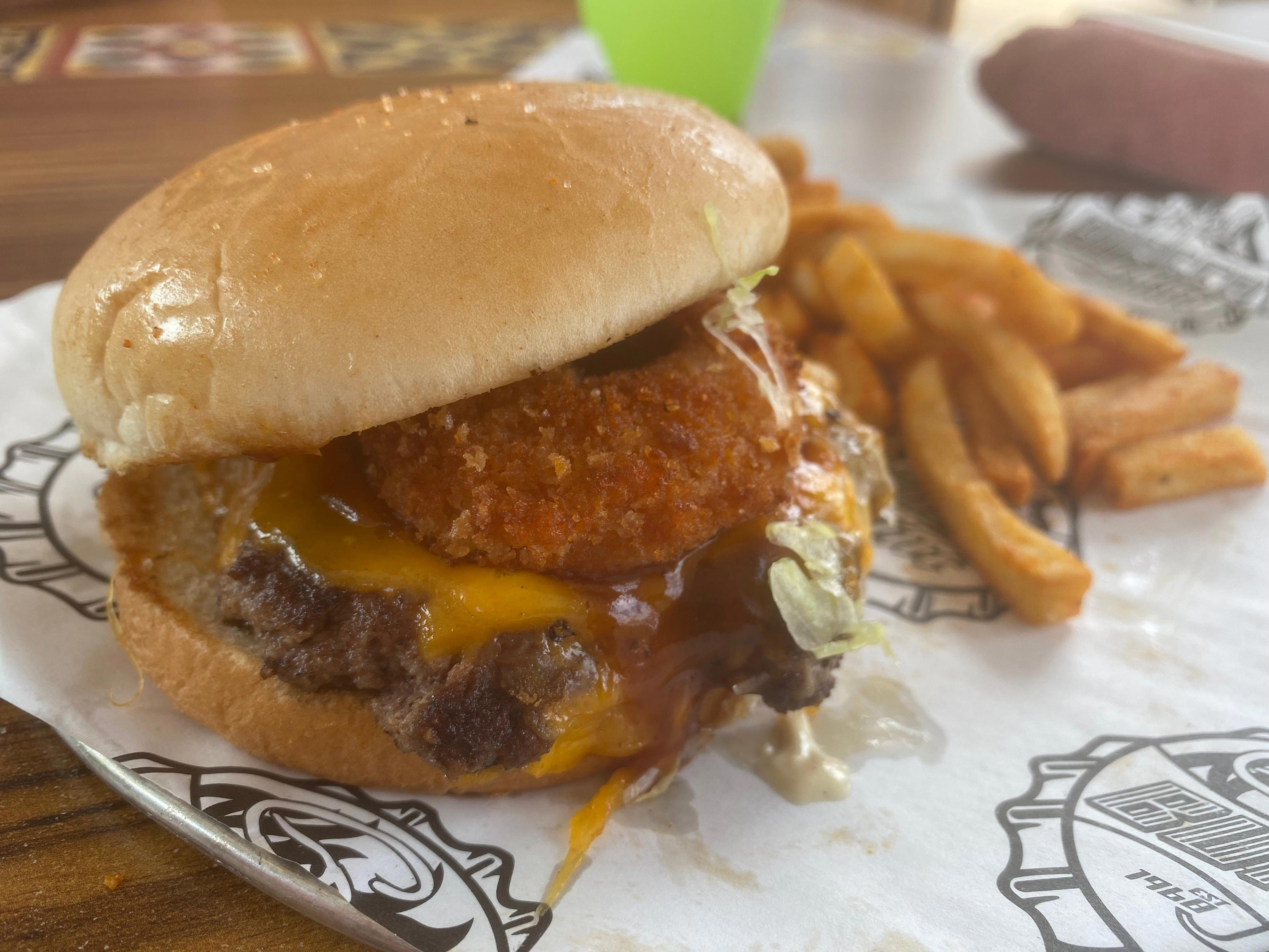 <p>The Ringer was dressed up with cheese, a crispy fried onion ring, and Fieri's bourbon-and-brown-sugar barbecue sauce, which was a bit spicy.</p><p>All of the sauces made the burger a little messy, but it was nothing a napkin couldn't fix.</p><p>The one bad thing about the Ringer was that the onion ring got soggy fairly quickly. Next time I order it, I'll ask for a few onion rings on the side and eat them along with the burger.</p>