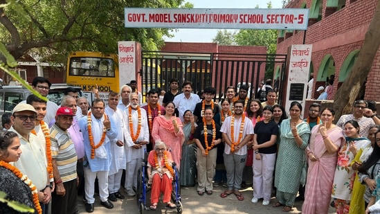 Delhi Lok Sabha polls: Mira Devi, 85, and children voting for the first time were honoured with flower garlands by the RWA in sectors 3, 5, and 6 in New Delhi on Saturday.