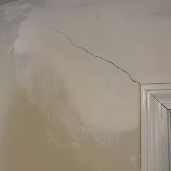 Before which shows a two-foot crack on a reviewer's wall