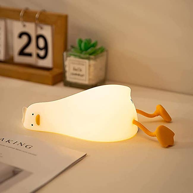 A light up duck laying on its side with a face of just complete bone deep existential despair