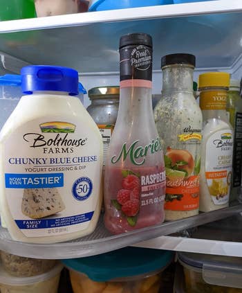 Condiments propped on a clear plastic turning tray installed in a fridge