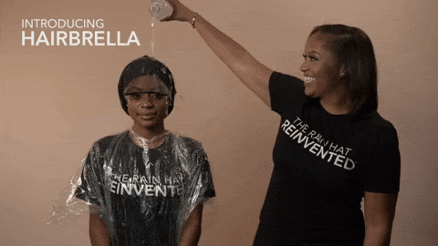 Model pouring water on another model's head while wearing the hairbrella, then taking it off to show hair perfectly styled and dried