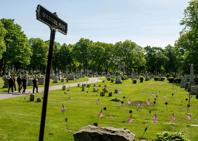 WORCESTER - The Soldiers Plot at Saint John's Cemetery is decorated with American flags for Memorial Day Wednesday, May 25, 2022. Volunteers from area veterans' groups, the Worcester County Sheriff's Office, and local businesses placed 5,000 American flags on graves in the cemetery.