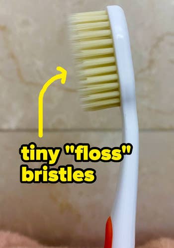 BuzzFeeder's photo of the toothbrush, with an arrow pointing towards the bristles with text: tiny