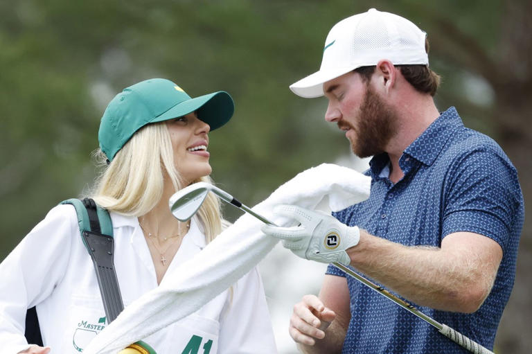 Grayson Murray, seen here with fiancee Christiana walking to the first hole of the Masters Par 3 Contest in Augusta, Ga., in April, died Saturday morning after withdrawing from the Charles Schwab Challenge due to an illness Friday by John Angelillo/UPI