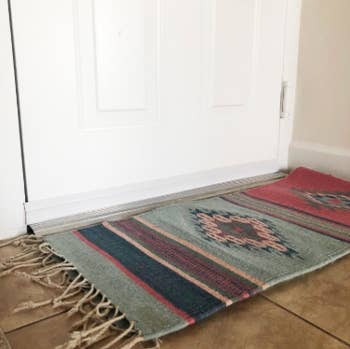 reviewer pic of white door with barely noticeable door draft stopper at the bottom