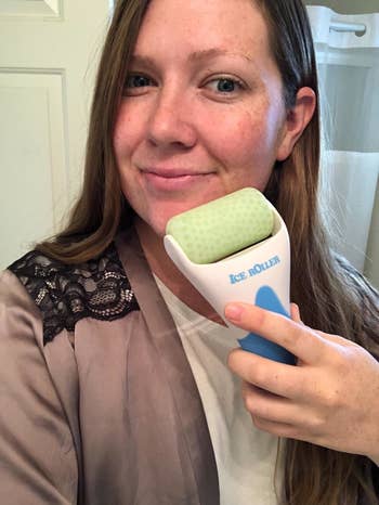 reviewer using an ice roller on their face