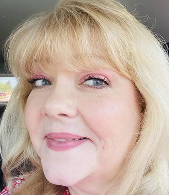 reviewer wearing the sunscreen showing that it blends in flawlessly under their makeup