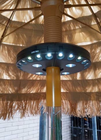 a reviewer photo of the light installed on a table umbrella pole