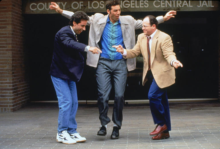 From left, Jerry (Jerry Seinfeld), Kramer (Michael Richards) and George (Jason Alexander) celebrate Kramer's release from jail in a "Seinfeld" episode where Kramer is mistaken for a serial killer. Richards goes behind the scenes of the show in his upcoming biography, "Entrances and Exits."