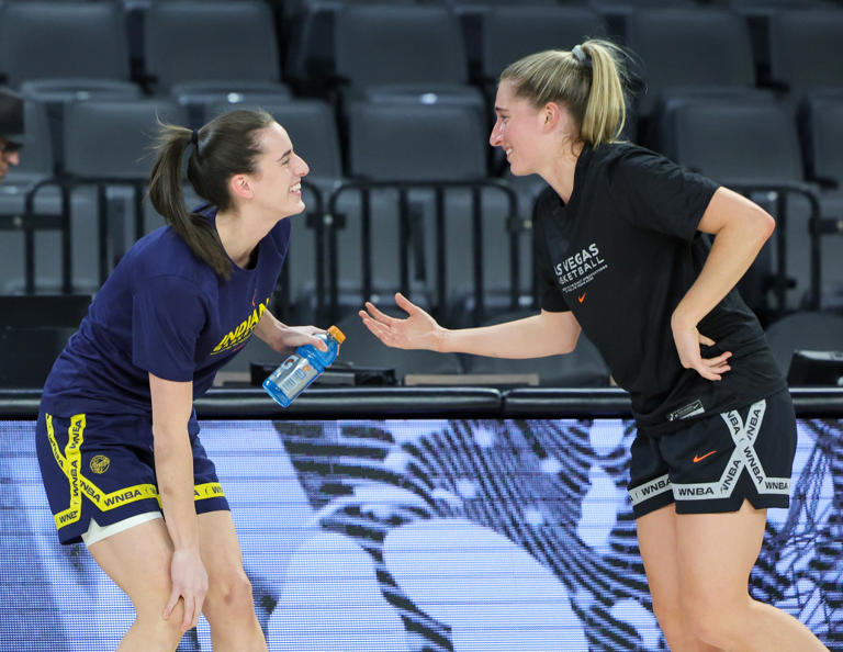 LAS VEGAS, NEVADA - MAY 25: Former Iowa Hawkeyes teammates Caitlin Clark (L) #22 of the Indiana Fever and Kate Martin #20 of the Las Vegas Aces greet each other on the court during warmups before their game at Michelob ULTRA Arena on May 25, 2024 in Las Vegas, Nevada. The Aces defeated the Fever 99-80. Ethan Miller/Getty Images