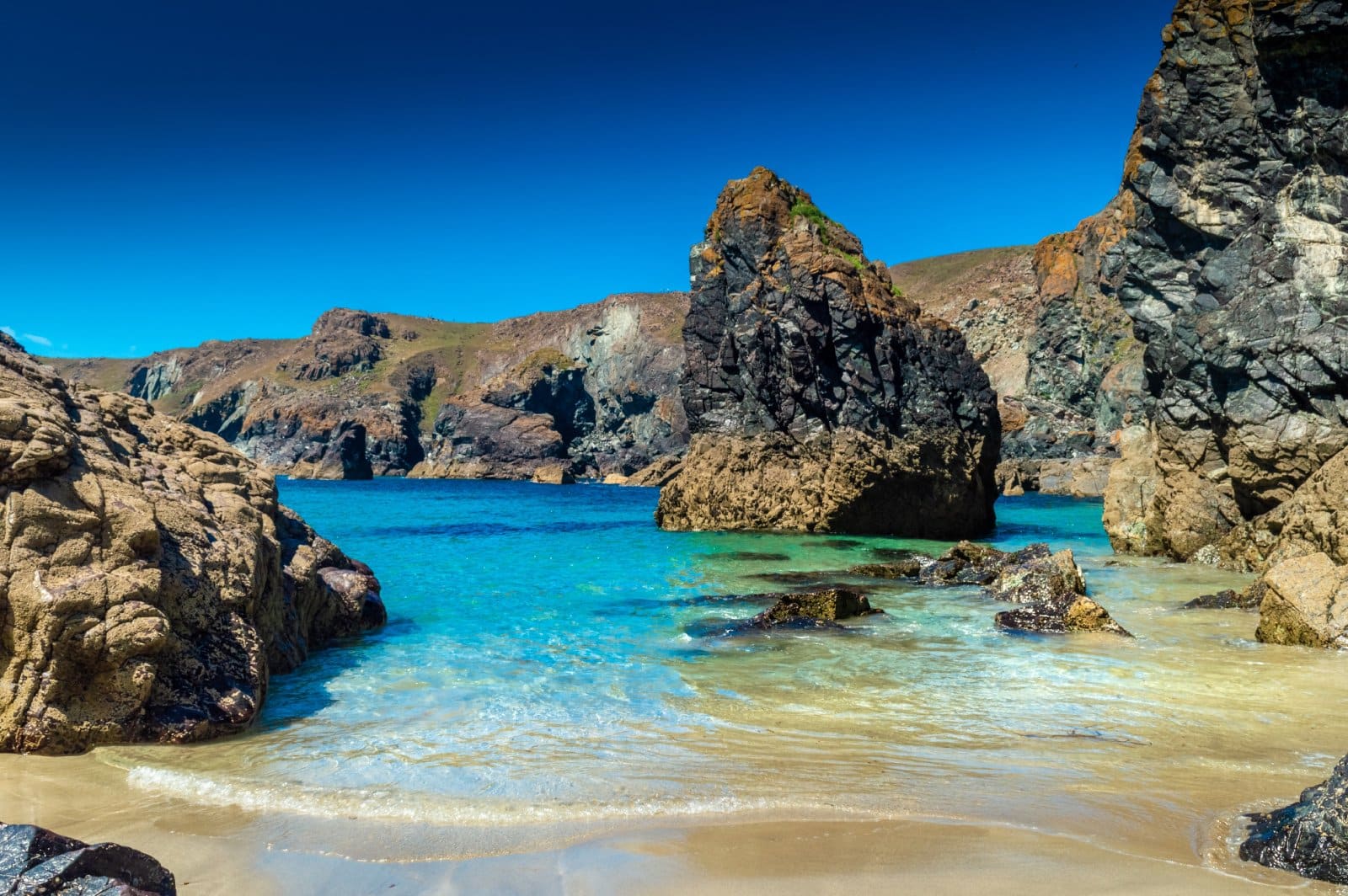 Image Credit: Shutterstock / Stefano Zaccaria <p>Kynance Cove’s turquoise waters and serpentine rock formations are Cornwall’s best-kept secret. Just be prepared for a bit of a hike down—and the reality that many others have discovered this ‘secret’ too.</p>