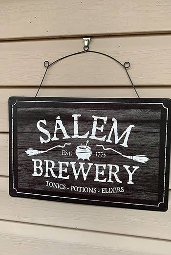 a reviewer photo of a sign hung up on the hook