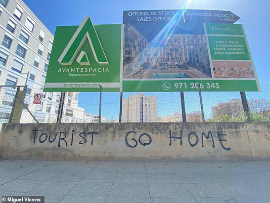 'Tourist Go Home' is seen scrawled in English over a wall underneath a real estate promotion billboard in Nou Llevant, Majorca, a neighbourhood that has seen a massive influx of foreign buyers over the past few years. It is one of many instances of anti-tourism graffiti