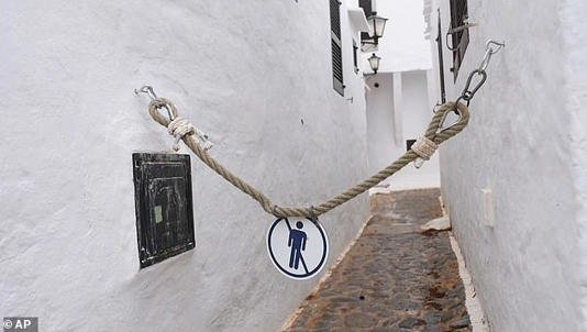 Angry locals have attached no trespassing signs to ropes and chains around the town n a bid to deter visitors