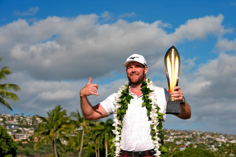 Grayson Murray holds the trophy after winning the Sony Open golf event, on Sunday, Jan. 14, 2024, at Waialae Country Club in Honolulu. (AP Photo/Matt York)