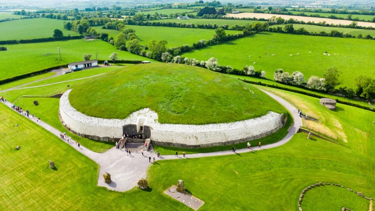 <p><strong>Age</strong>: Approximately 5,200 years old (3200 BC)<br><strong>Location</strong>: County Meath, Ireland </p> <p>Rising from the green hills of Ireland’s Boyne Valley, the ancient passage tomb of Newgrange is a masterpiece of prehistoric engineering. Built around 3200 BC, this massive stone structure predates the Egyptian pyramids by several centuries and is one of the oldest surviving buildings in the world.</p> <p>What sets Newgrange apart from other ancient monuments is its precise alignment with the rising sun on the winter solstice. Each year on December 21st, a beam of light penetrates the tomb’s narrow passageway, illuminating the inner chamber for just a few precious minutes. (<a href="https://www.newgrange.com/winter_solstice.htm">ref</a>)</p>