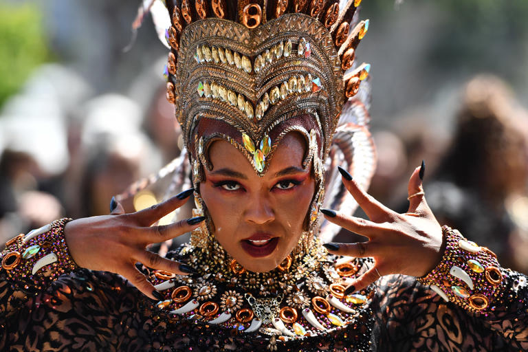 A parade participant performs during the Grand Parade Carnaval San Francisco in San Francisco, Calif., on Sunday, May 26, 2024. The parade covers 20 blocks in the Mission District with over 3,000 artist participating in the event.