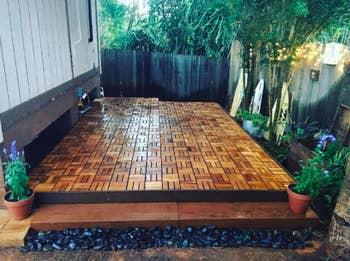 reviewer's deck with brown interlocking Teak tiles