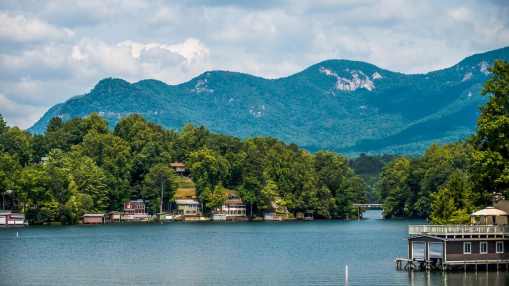 <p>Tucked away within the Blue Ridge Mountains, Lake Lure is a picturesque town known for its scenic beauty and tranquil atmosphere. The lake provides a variety of water activities, including boating, fishing, kayaking, and swimming.</p><p>Hike to the top of Chimney Rock for breathtaking views of the lake and surrounding mountains. Visit the Lake Lure Flowering Bridge, a pedestrian bridge adorned with colorful blooms. Or simply relax on the <a href="https://www.romanticasheville.com/lake_lure.htm">shores</a> of the lake and soak up the peaceful ambiance.</p>