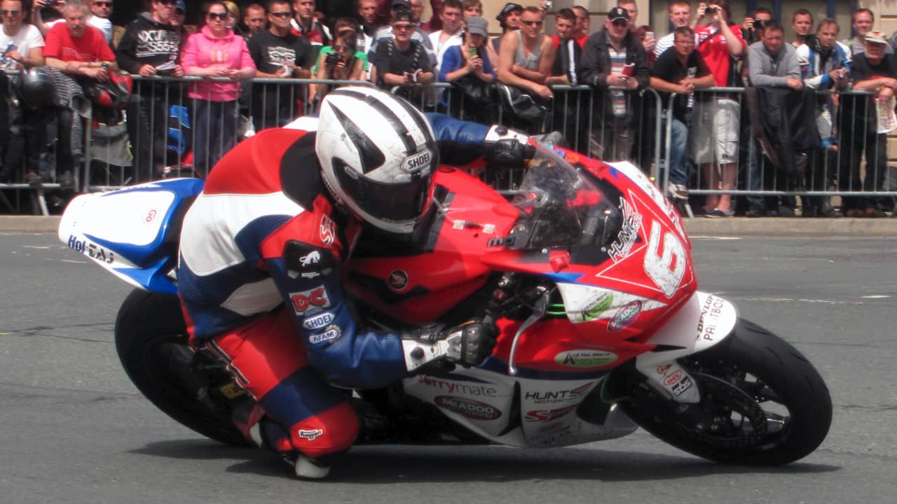 <p>What is it about the human need for an adrenaline rush that comes with speed? The Isle of Man TT (Tourist Trophy) Races are among the most dangerous motorcycle races in the world. Held annually on public roads closed for the event, riders navigate the challenging 37.73-mile course at speeds exceeding 130 mph.</p><p>The narrow, winding roads are lined with stone walls, lampposts, and buildings, leaving little room for error. Since the event’s <a href="https://www.news.com.au/sport/motorsport/worlds-fastest-death-cult-the-most-dangerous-race-on-the-planet/news-story/e1a4b17cc4e577ba79737a64da501dbc">inception</a> in the early 20th century, over 260 professional and amateur riders have lost their lives. Despite the dangers, the TT Races continue to draw riders and fans from around the globe.</p>