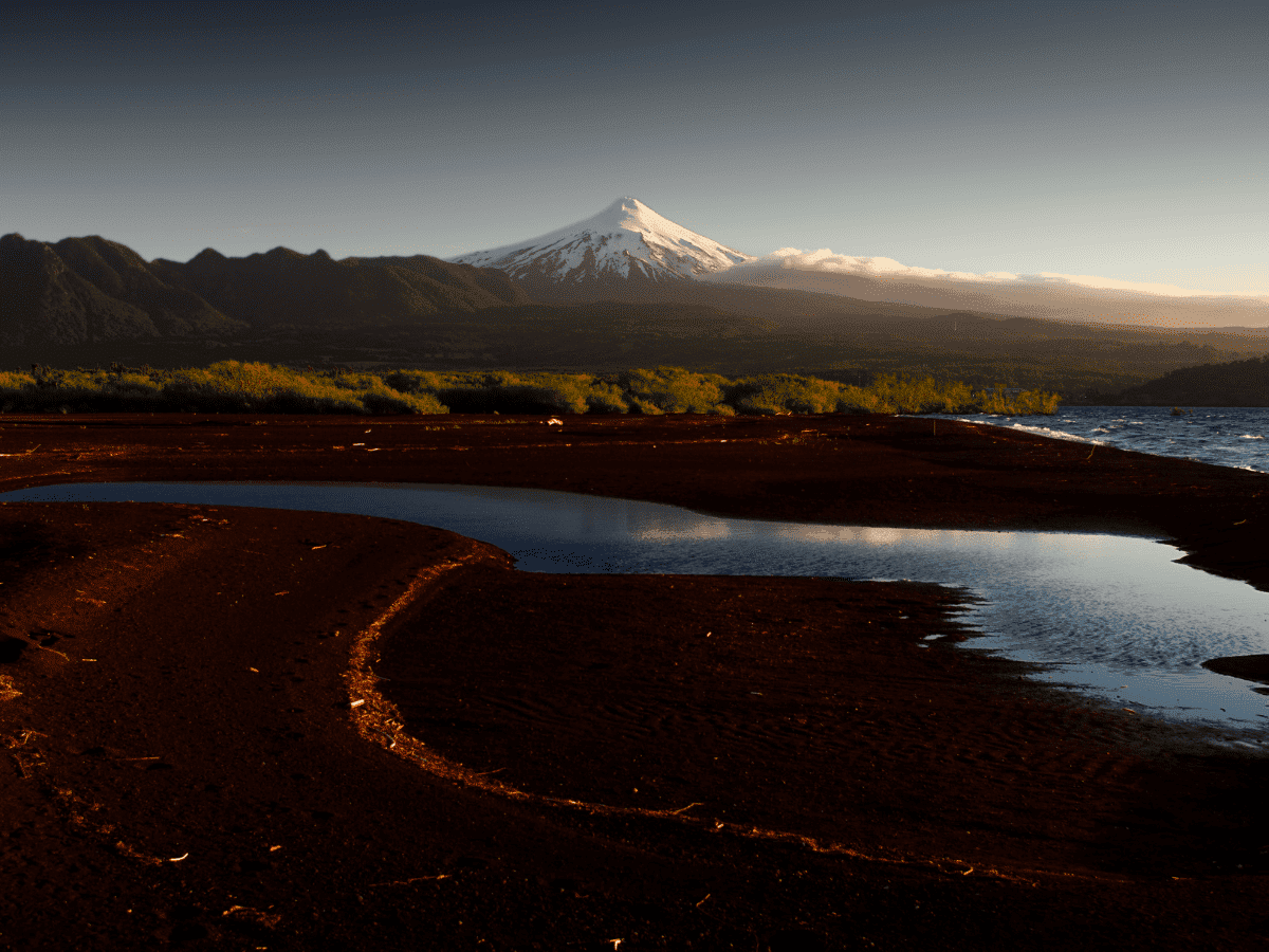 <p>Villarrica Volcano, situated in Chile’s Lake District, is renowned for its symmetrical cone and gorgeous surrounding countryside. Standing at 9,341 feet tall, it’s a popular destination for adventure seekers who can hike to its summit.</p>