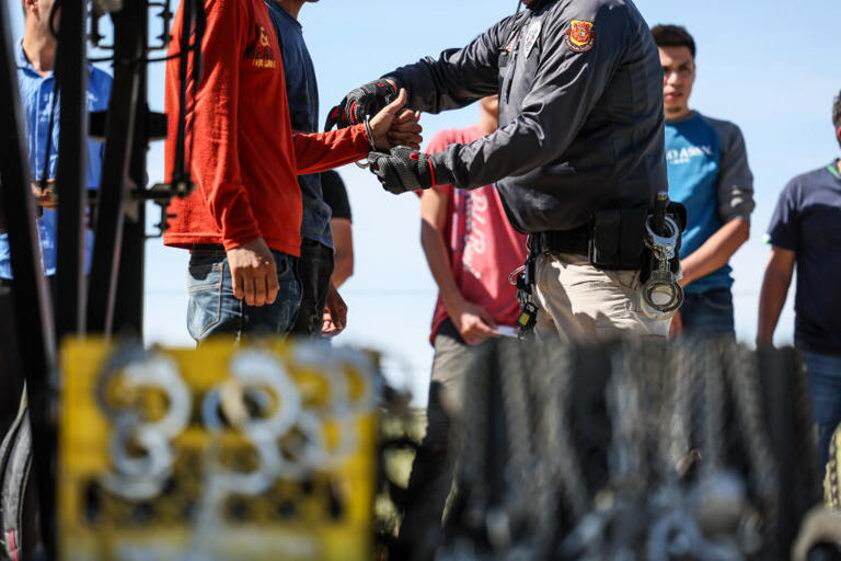 Men seeking asylum are detained Monday by Border Patrol after crossing from Mexico into the United States. ((Robert Gauthier / Los Angeles Times))