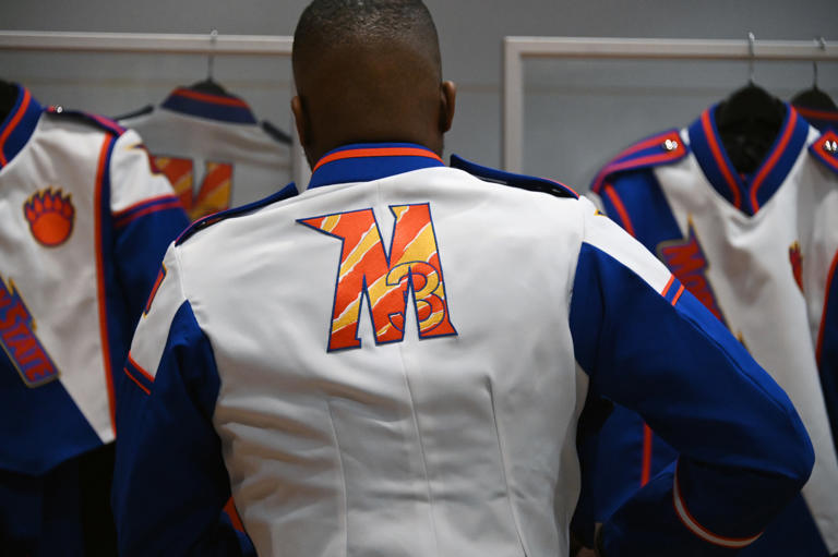 Tionne Blackwell, a Magnificent Marching Machine tuba player, tries on a new band uniform. Morgan State University's marching band is leaving for its first international trip. Over 140 people are headed to France to perform for the 80th anniversary of D-Day.