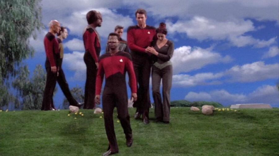 <p>Later, Jonathan Frakes confirmed her account, saying “That’s an episode where we were all crying as our characters and ourselves.” If you go back and rewatch the scene, Deanna Troi clearly has tears running down her cheeks, and you can see Jonathan Frakes trying to swallow down his rising emotions during Tasha Yar’s funeral. In one particularly touching moment, Troi clutches Riker’s hand that he has placed over his shoulder, and it’s clear that Sirtis herself is drawing emotional support from her onscreen Imzadi.</p>