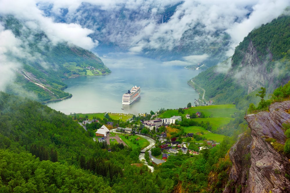 <p>If you are looking for a picturesque village that seems straight out of a fairy tale, then Geiranger is the perfect place. Located in western Norway, this small village is known for its stunning scenery and natural beauty.</p><p>Geiranger is situated at the end of the Geirangerfjord, one of Norway’s most famous and deepest fjords. Steep mountains and tiny waterfalls surround the fjord.</p><p>The best way to experience Geiranger is on the water. Several sightseeing boats make their way through Geirangerfjord multiple times a day. You just need to pick a time!</p>
